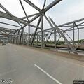 Pedestrian walking on Shade-Lohmann Bridge shoulder
