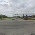 Traffic stop involving green dump truck on trailer
