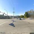 Person hunched over at bus stop in Thousand Oaks