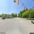 Officers check on man lying in grass near intersection