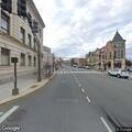 Disabled gray Honda partially blocking roadway