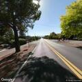 Woman dragging mattress and carts on Mountain View Ave