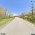 Ditch fire near homes and propane tanks