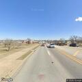 Person walking on highway shoulder, waving arms