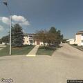 Woman semi-conscious and rolling on grass at apartment