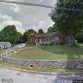 Person removing plywood and entering vacant house