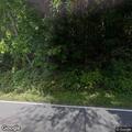 Low-hanging tree limb causing road hazard