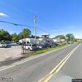 Car hits parked vehicle and business fence in lot