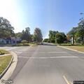 Suspicious man with backpack and slow white SUV