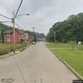 Utility poles snapped and hanging by wires