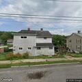 Phone call about small white dog at Maple Street