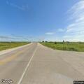 Person asleep in maroon truck on highway in Moorland