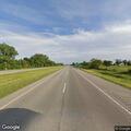 Vehicle with flat tire in ditch on US-23