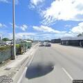 Female experiencing abdominal pain on sidewalk in Miami