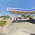 Woman leaves and retrieves bag at Bay City gas station