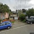 Person sleeping in parked minivan on Alvarado Street