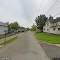 Person struggling with bicycle on Melvin Avenue