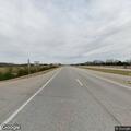 Male driver leaning over steering wheel in median