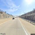Officer checks red vehicle on highway on-ramp