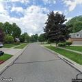 Power line sparking against trees behind home