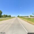 Car with flat tire after hitting object on highway