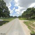 Man yelling on phone near Lake Wales park