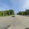 Vehicle follows woman walking along highway