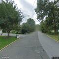 Tree falls on parked car in front yard