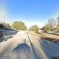 Person with bat blocking traffic on Comanche Avenue