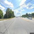 Traffic lights flashing yellow at busy intersection