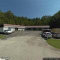 Person sleeping beside building on Highway 41