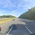 Pedestrian walking in highway breakdown lane