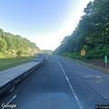 School bus travels with rear panel open on highway