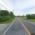 Person unresponsive in parked dark sedan on roadside