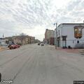 Man wandering near bus stop with large bag in Milwaukee