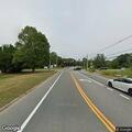 Gray sedan reported in tree line near cemetery