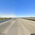 Pedestrian walking on freeway shoulder at Reed