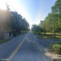 Vehicle partially blocking road near school