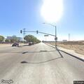 Pedestrian pushing cart on freeway shoulder