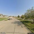 Officer checks duplex with U-Haul in driveway