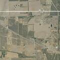 Large grass fire spreading toward structures