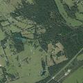 Brush fire in field near brick house entrance