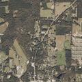 Brush fire near pine plantation threatens house