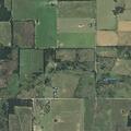 Grass fire spreading near structures on County Road 380
