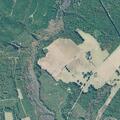 Grass fire spreading toward pasture and buildings