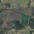 Farm equipment rollover into creek injures man