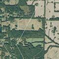 Field fire spreading toward woods in Mason