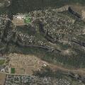 Woman with worsening back pain on front steps in Los Alamos