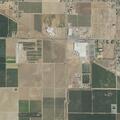 Grass fire in dry canal spreads toward fence; reported reaching power lines