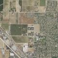 Man chasing woman in field near Kingsburg apartments